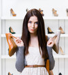 © Karramba Production - Woman keeps two heeled shoes in the shopping mall