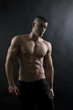 © kalcutta - Young sexy man with athletic body on black background