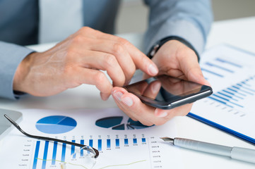 Wall Mural - close-up of businessman using cell phone