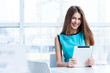 © MaxFrost - young happy woman using tablet computer in a cafe