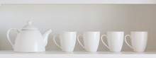 Teapot And Cups On The Shelf