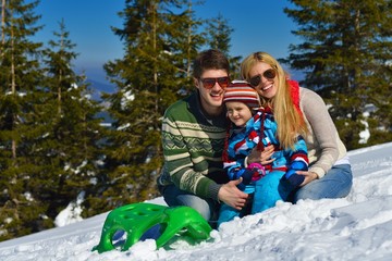  family having fun on fresh snow at winter