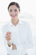 © lightwavemedia - Smiling business woman with hand gesture