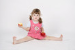 © singulyarra - Little beautiful girl eats apple and holds second apple on floor