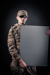 Sticker - Modern soldier is holding a poster