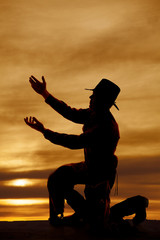 Wall Mural - cowboy kneel silhouette both hands up