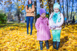 © travnikovstudio - Two adorable girls with his young mom in the park on a sunny