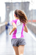 City runner - woman running on Brooklyn Bridge