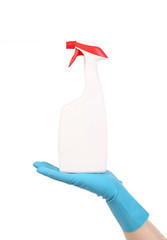 Hand in glove holding white plastic spray bottle