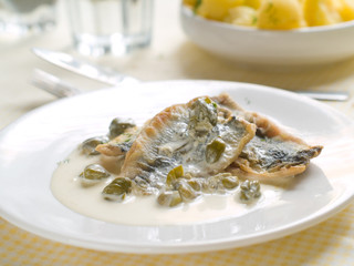 Poster - Fish fillet with lemon sauce and capers, selective focus