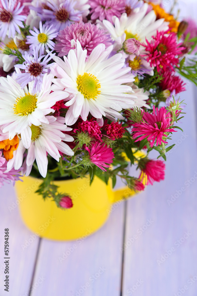 Wildflowers in mug on wooden table
