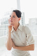 © lightwavemedia - Thoughtful businesswoman standing in office