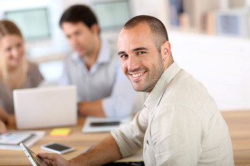 Young man in office working on digital tablet