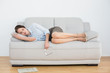 © lightwavemedia - Well dressed young woman sleeping on sofa
