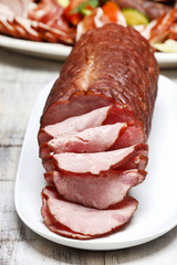 Sliced sausage on wooden table