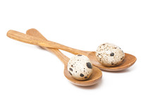 Quail Eggs In A Wooden Spoon Isolated On White
