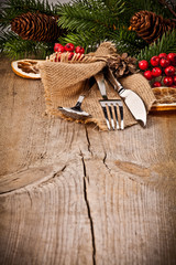 Vintage silverware on rustic wooden background with christmas de