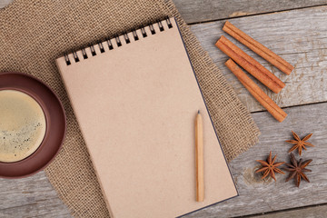 Wall Mural - Blank notepad with coffee cup and spices on wooden table