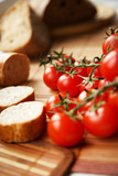 Fototapeta Miasto - Bread and tomatoes on the kitchen table