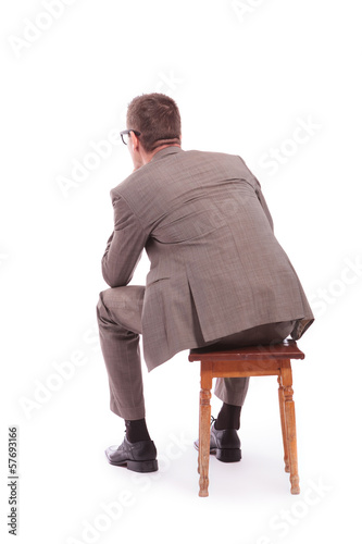 Fotografía back of a young business man sitting on a chair
