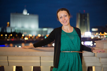 Wall Mural - Pretty girl in dress on a background of night city