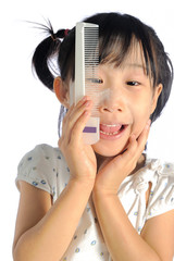 smiling asian little girl with applying make up baby powder on f