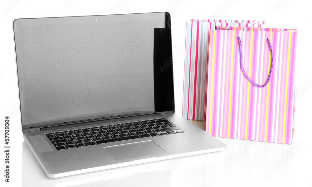 Laptop and handbags isolated on white