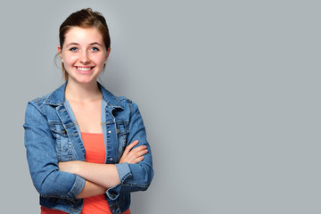 Teenage girl standing with crossed arms