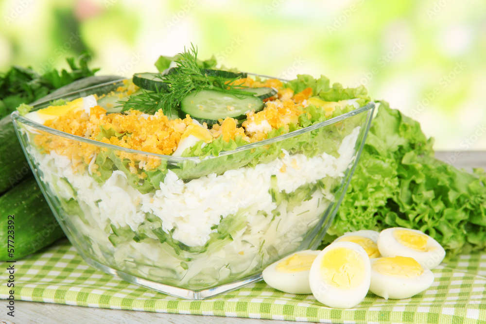 Delicious salad with eggs, cabbage and cucumbers on wooden