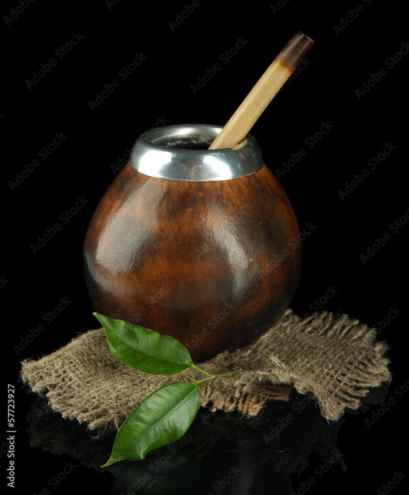 Calabash and bombilla with yerba mate isolated on black