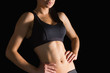 © WavebreakMediaMicro - Mid section of slender sporty woman posing in sportswear