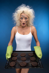 Fototapete - Burnt cookies. Funny blond girl have trouble with cooking