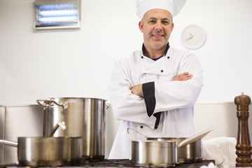 Sticker - Smiling head chef standing arms crossed behind pot