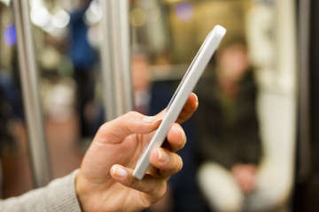 Wall Mural - Woman using her cell phone in Subway