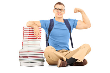 Sticker - Smiling male student with bag near books showing his biceps