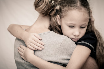 sad daughter hugging his mother