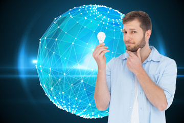 Poster - Composite image of handsome model holding a bulb