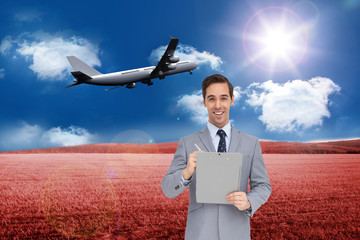 Poster - Composite image of happy businessman holding a clipboard