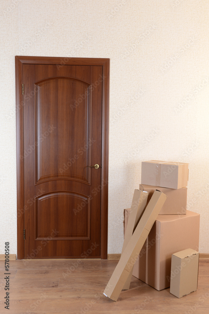 Empty room with stack of cartons: moving house concept