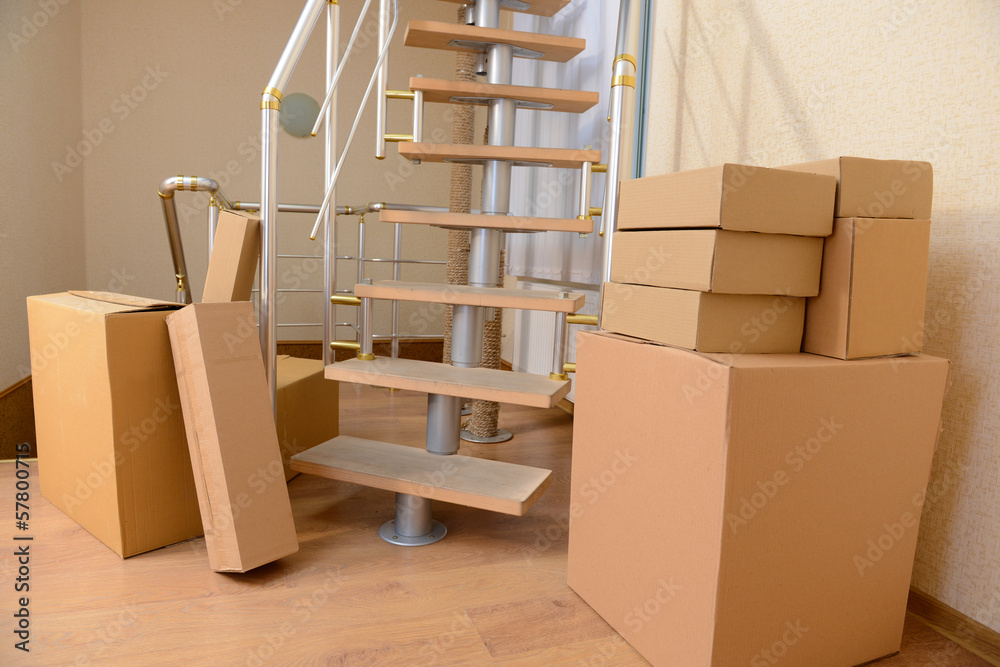 Stack of cartons near stairs: moving house concept