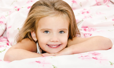 adorable smiling little girl awaked up