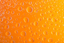 Clear Orange Water Drops Over Orange Background