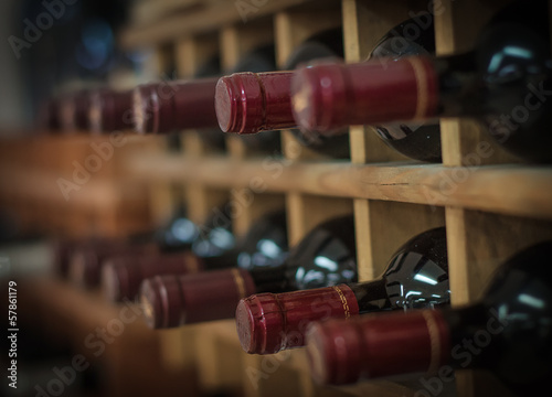 Cuadros en Lienzo Red wine bottles stacked on wooden racks
