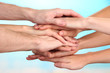 © Africa Studio - United hands on bright background. Conceptual photo of teamwork