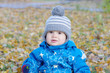 portrait of lovely baby in gray hat in autumn outdoors