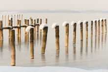 Snow Capped Pier Posts On A Frozen Lake I