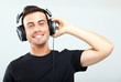 © Minerva Studio - Young man listening to music with earphone