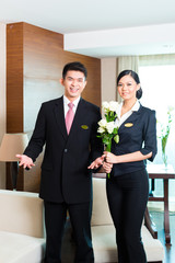 Asian Chinese hotel manager welcoming VIP guests