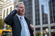 © blvdone - Caucasian businessman in New York City on cellphone