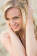 © WavebreakmediaMicro - Smiling relaxed young blond looking away at beach